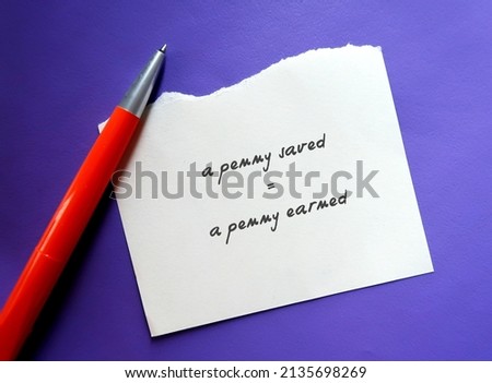 Torn paper on purple background with handwritten text - a penny saved = a penny earned - advise people to be cautious of their money and have savings, spend less money is useful as it is earned  Zdjęcia stock © 