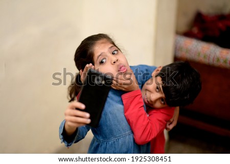 Similar – Image, Stock Photo Brother and sister playing on the field at the day time. Children having fun outdoors. They running on the lawn. Concept of friendly family.