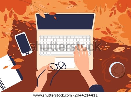 Top view on female hands working behind a laptop on the grass in an autumn park. Flat vector illustration of freelance outdoors