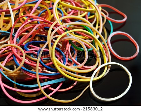 Bunch of colorful and elastic rubber on black background.