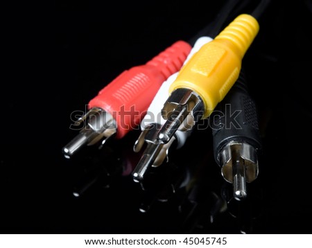 Closeup of component audio and video cables on a dark background.