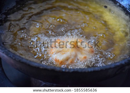 Picture of frying modak or sweet mo-mos in ghee . Modak made during the Ganpati festival in maharashtra Stock fotó © 