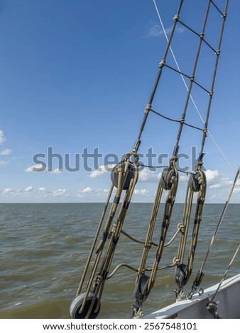 Similar – Image, Stock Photo a taut rope on the beach holding up a boat