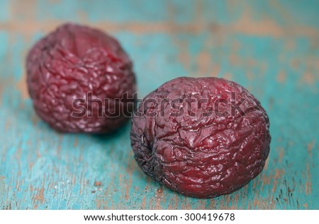 Dried cherries on wood background.