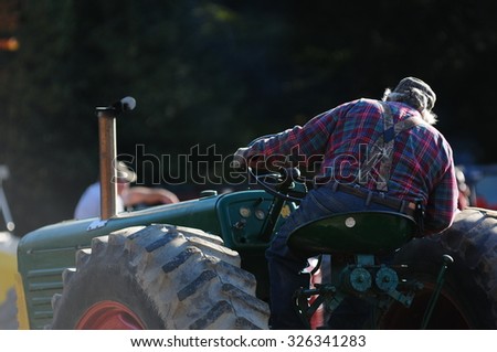 A New Hampshire farmer rides an antique tractor at the Sandwich Fair in Sandwich, New Hampshire, USA, on October 11, 2015.