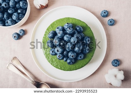 Similar – Image, Stock Photo Matcha cheesecake flat lay. Woman hands taking cake slice