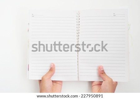 Woman hand carrying empty book on white paper background.