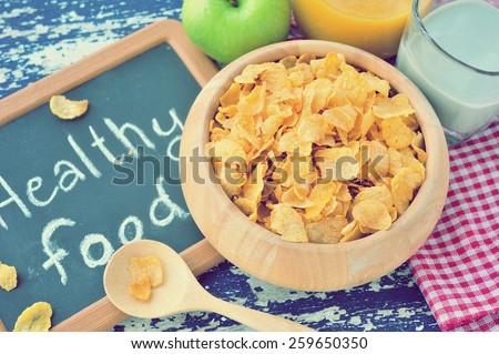 Corn flakes in wooden bowl with healthy food word on small blackboard,healthy food concept.