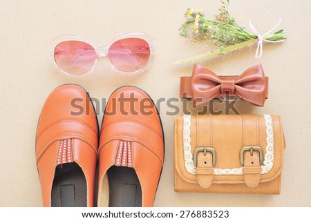Vintage leather shoes ,leather wallet,fashion eye wear and belt on wooden floor.