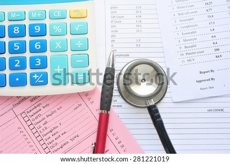 Stethoscope,pen  and calculator on lab paper.Health care costs.