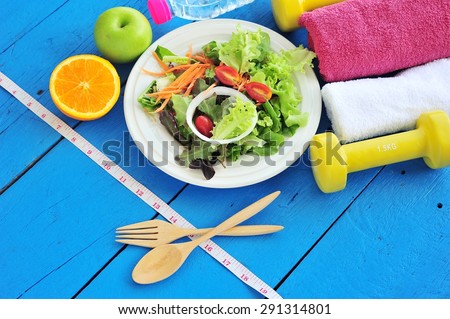 Fresh salad, fruits with sport and diet concept.