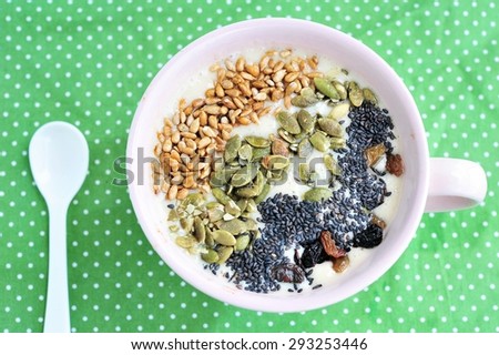 Yogurt,pumpkin seeds,sunflower seeds and black sesame in bowl.Healthy breakfast.
