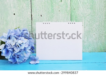 Blank calendar with hydrangea on paint wood background.