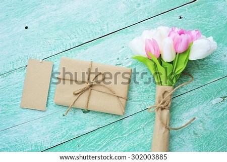 Handmade gift boxes with bouquet of flower on vintage wooden floor.