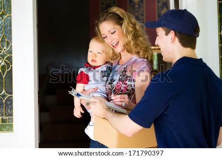 Delivery: Mother With Baby Signs For Package