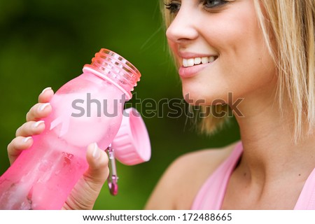 Park: Girl taking A Drink From Pink Water Bottle