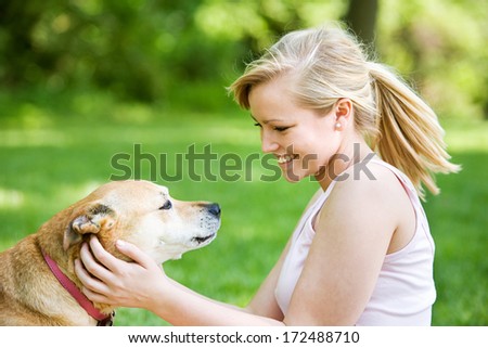 Park: Woman In Pink Playing With Dog