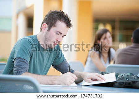 College: Serious Student Working At Outdoor Table