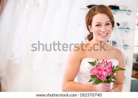 Bride: Woman In Store Trying On Gown With Bouquet
