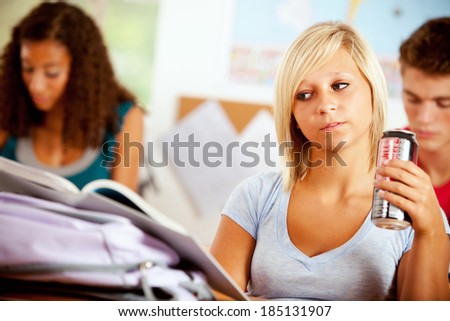Students: Bored Girl Drinking Soda In Class