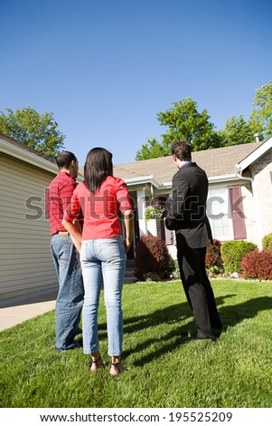 Home: Real Estate Agent Showing House To Buyers