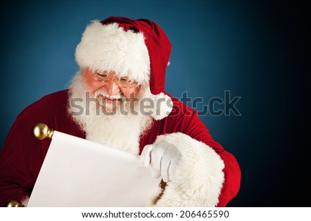Christmas: Cheerful Santa Claus Reading the Naughty and Nice List