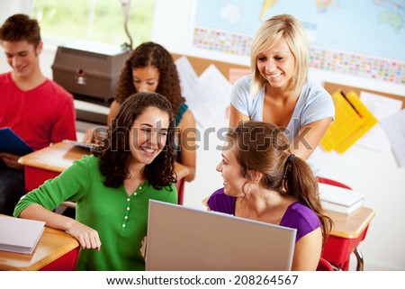 Students: Friends Sitting At Desk With Laptop Working On Homework