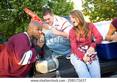 Tailgating: Group Of Fan Friends Listening To Game On Radio