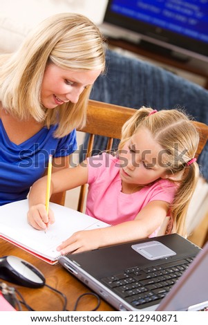 Student: Parent Supervises Girl On Homework