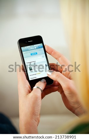 St. Louis, Missouri, USA - March 9, 2011: Woman Accessing Twitter Website On Apple iPhone 4