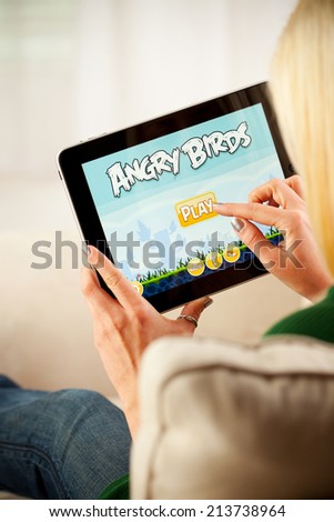 St. Louis, Missouri, USA - March 9, 2011: Woman Playing Angry Birds Video Game On Apple iPad 1