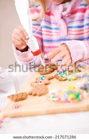 Christmas: Young Girl Using Icing To Decorate Cookies