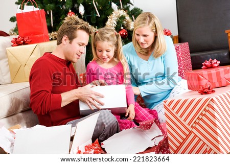 Holidays: Family Opens Gifts Together On Christmas Morning