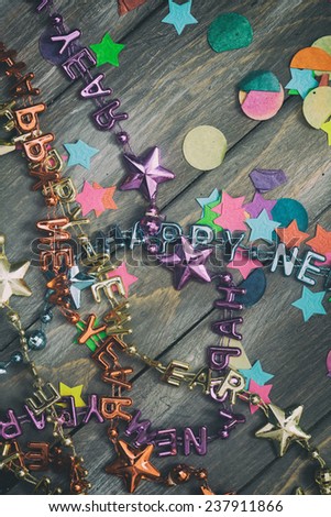 NYE Background: Confetti and Necklaces On Wood For New Year\'s