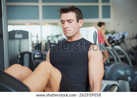 Gym: Muscular Man Works Out On Leg Press
