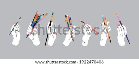 Hand holding paintbrushes. Hand drawn vector illustration of hands with art tools.  Doodle style. Workshop, art studio, workplace, artist, art shop, painting. Hand, palm, wrist, fingers, nails.
