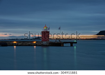 Lighthouse at Alesund and lights passing ship. Norway. Travel. From the series of lighthouses