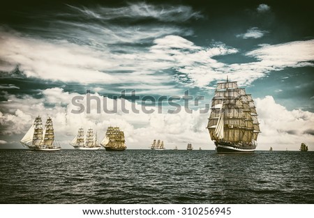 Sailing ships under sail. Toned image and blur. Retro style postcard. Sailing. Yachting.
