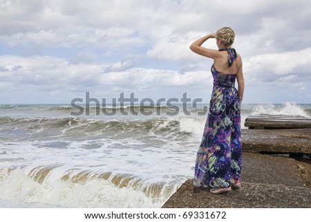Beautiful woman looking at the waves