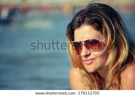 Beautiful girl natural looking retro color portrait outdoor enjoying  the sun by the sea - Young Caucasian woman fashion shoot by the sea
