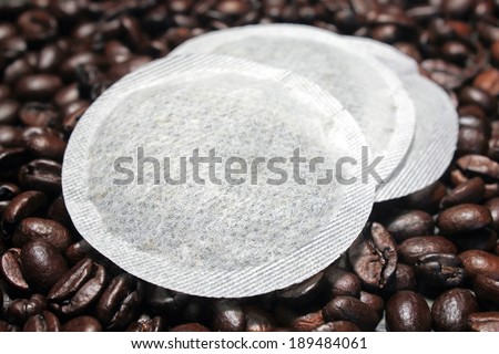 Coffee pods on coffee beans background - Coffee pads  modern filter coffee replacement