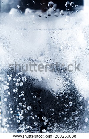 ice and water in a glass cup - closeup