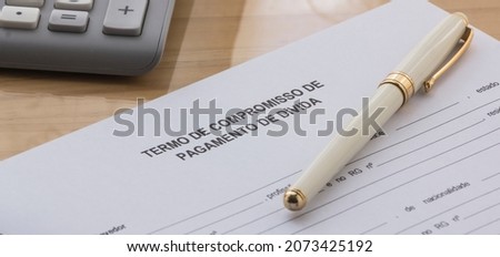 A Debt Payment Commitment Term in portuguese Language on the desk. Term of commitment form Stok fotoğraf © 
