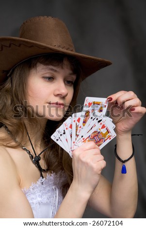 Portrait girl with a playing-cards in hand on black