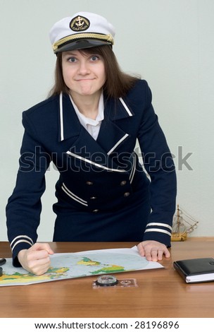 The woman in a sea uniform at table in office with map