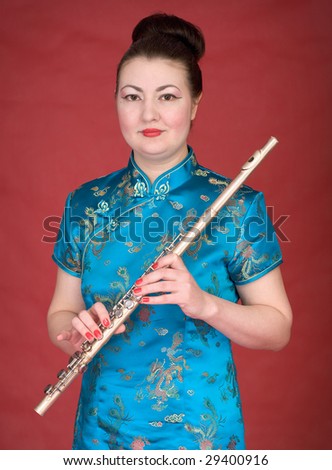 Japanese girl with flute on the red background