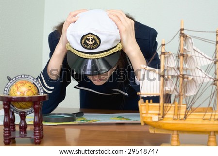 Girl - the sea captain with a card in office