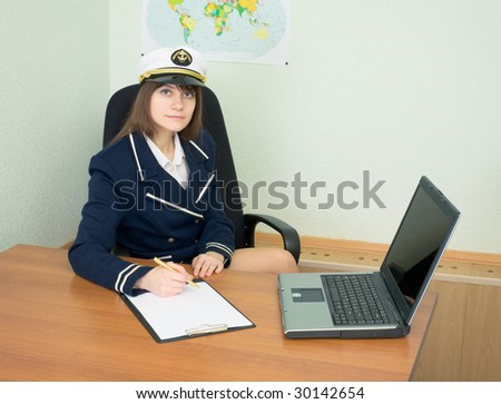 The girl in a sea uniform at office with laptop and tablet