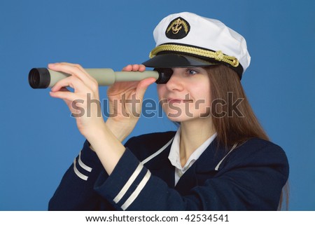 Portrait of the woman - captain with spyglass on a blue background