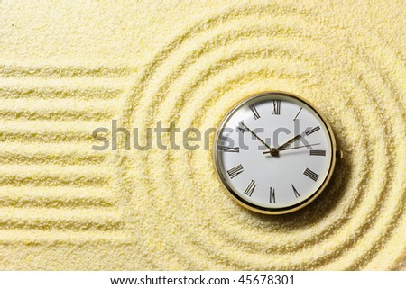 Composition on Zen garden - yellow sand, and watch